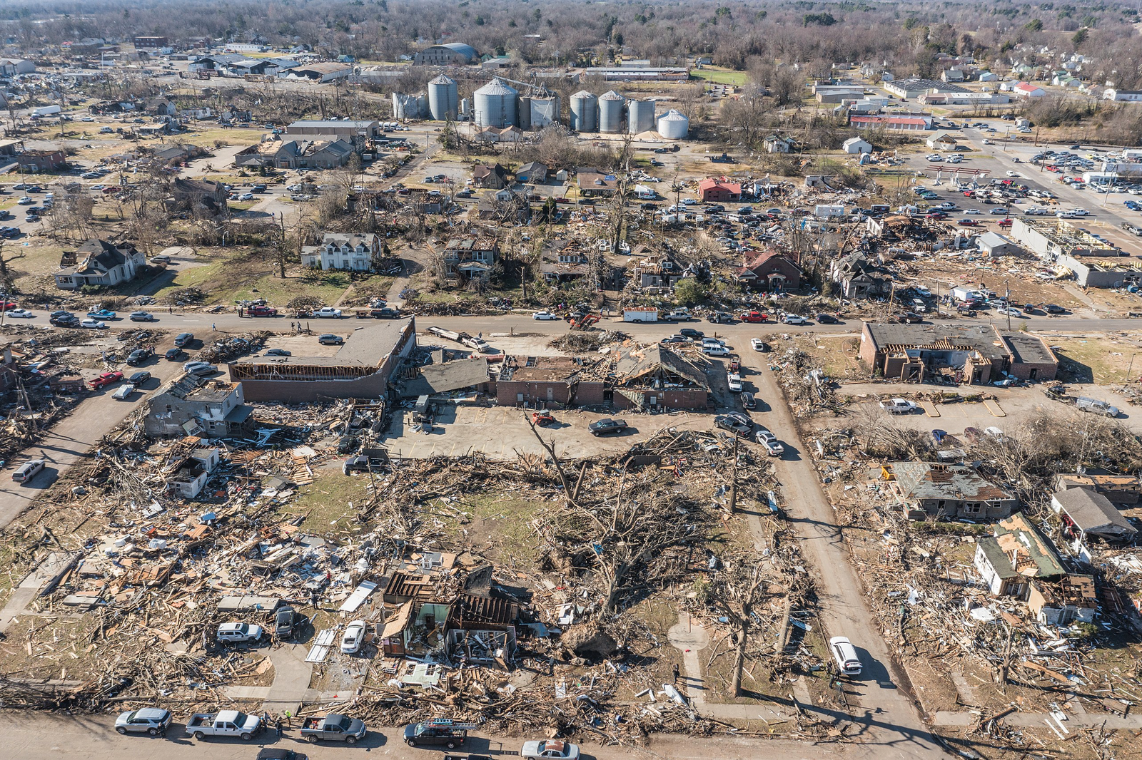Aerial view of disaster scene — buildings destroyed, comms infrastructure down